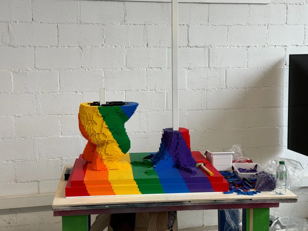 Front view of the construction process for the multicolored “Bear and Strawberry Tree” sculpture base made with LEGO