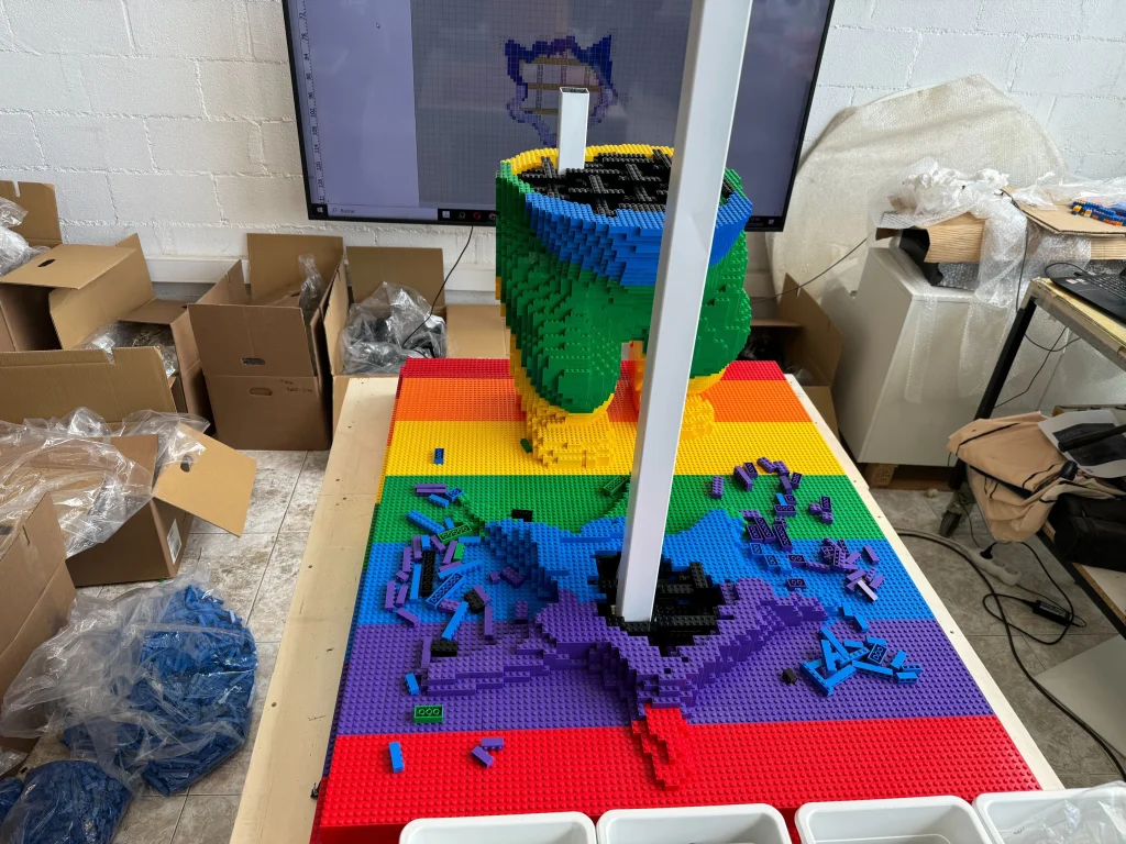Side view of the construction process for the multicolored “Bear and Strawberry Tree” sculpture base made with LEGO