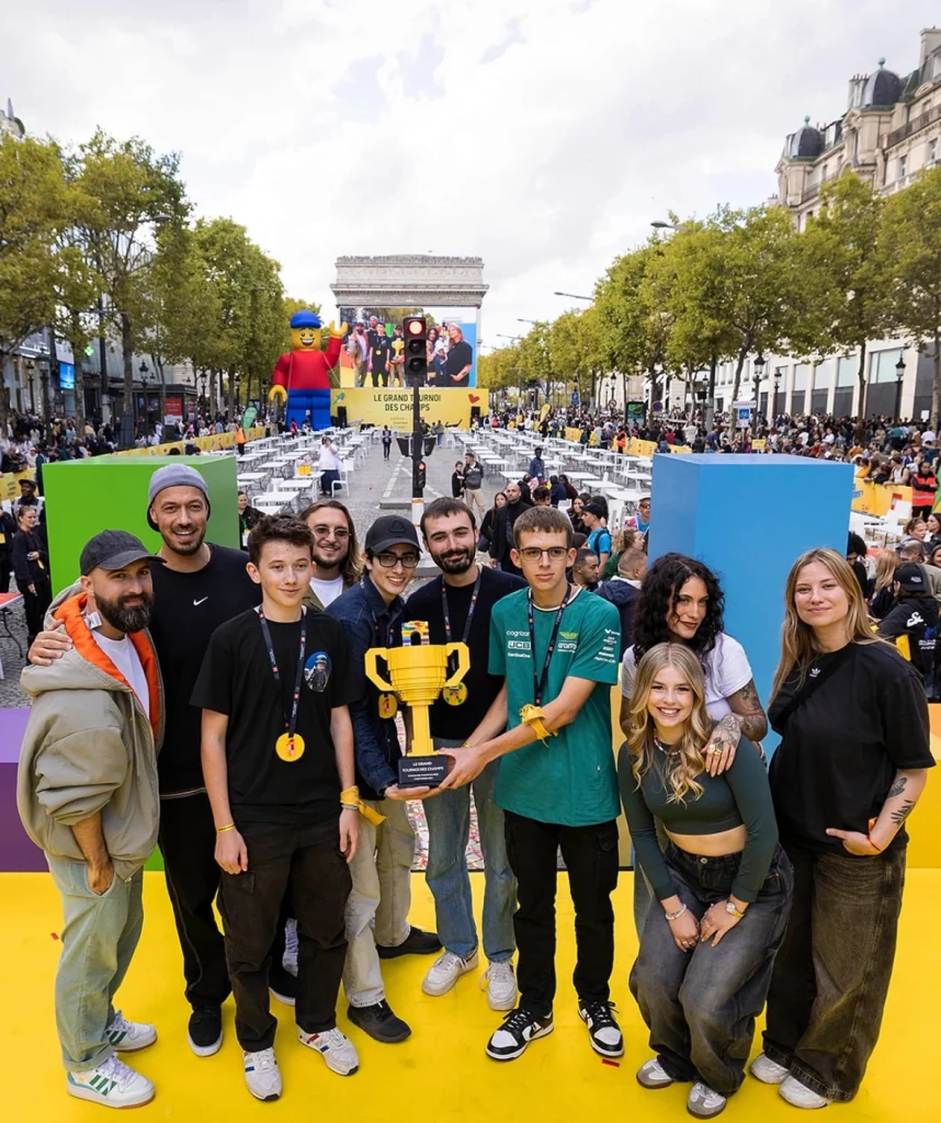 The winning team of the Grand Tournoi des Champs holding the LEGO trophy